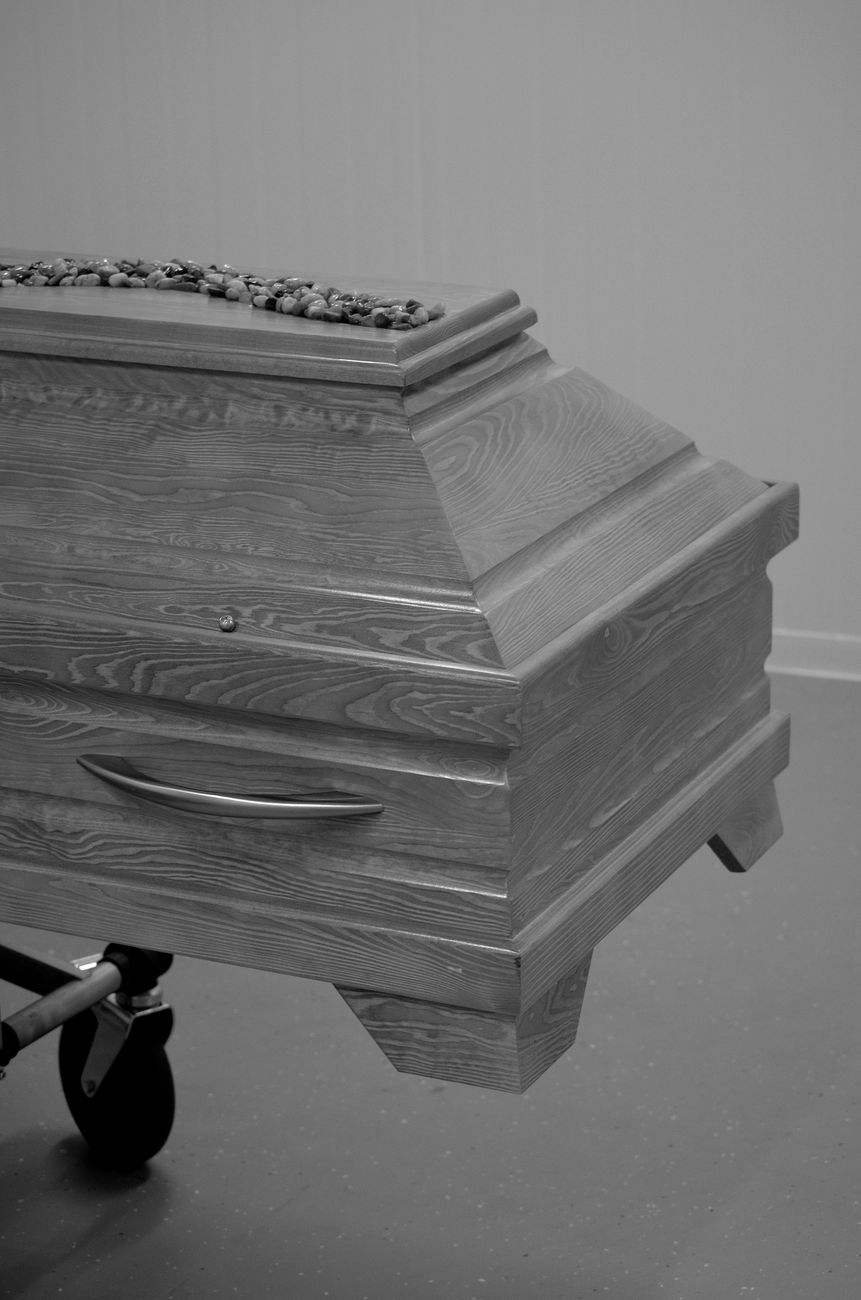 Home Monochrome image of a wooden coffin on a trolley in Bocholt, NRW, Deutschland.